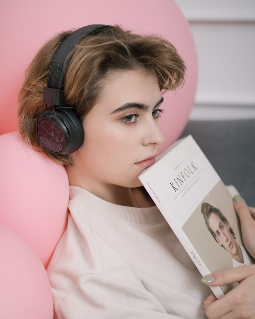 woman listening on black headphones